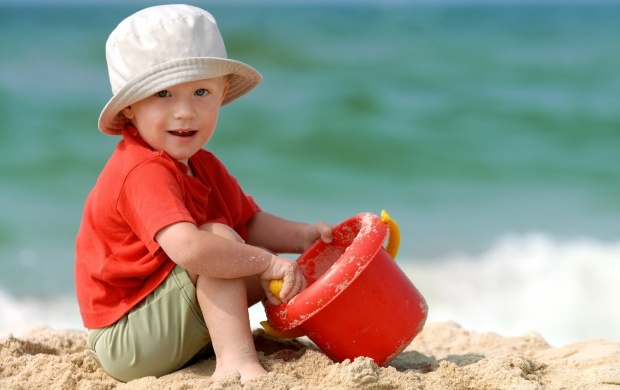 Baby Boy Playing On Beach Sand