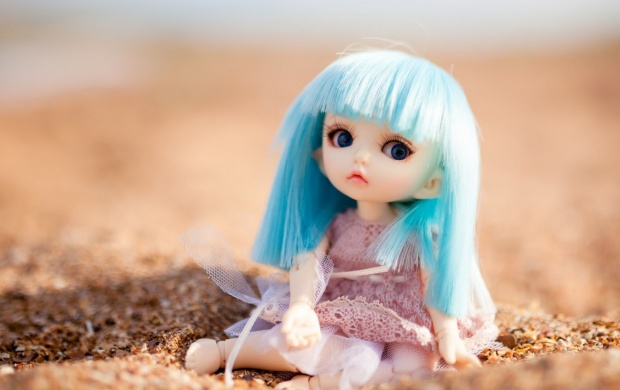 Blue Hair Doll Sitting At Sand