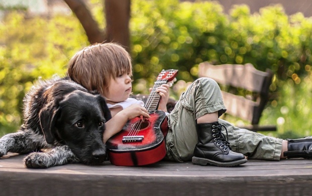 Cute Boy Playing Guitar With Dog