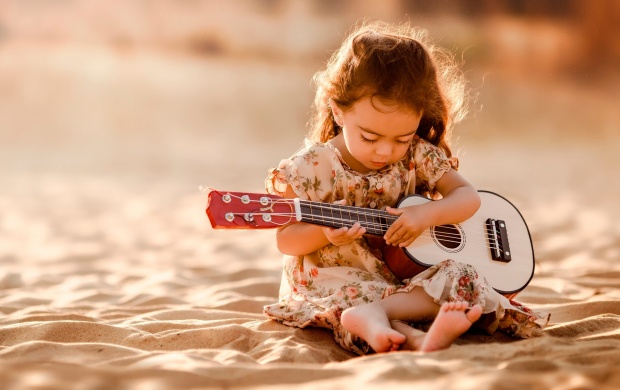 Cute Guitarist On Sand
