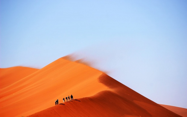 People Walking On Sand Dune