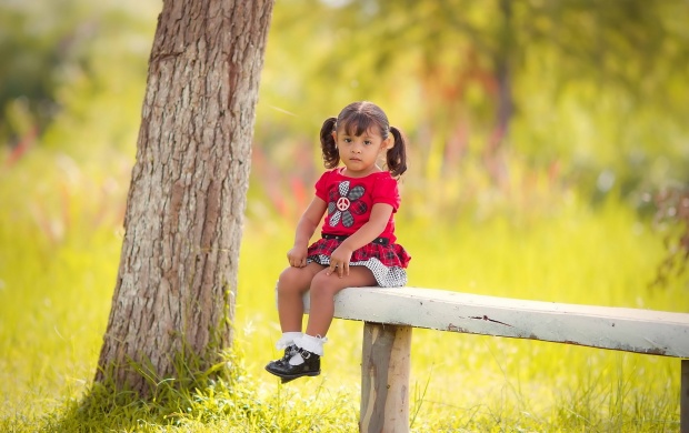 Sad Little Girl Sitting On Bench