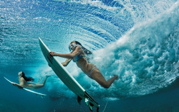 Surfing Girls Under A Wave