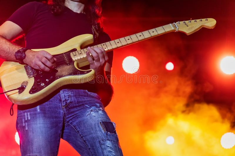 Bass player in action on stage performing at a rock concert editorial stock image