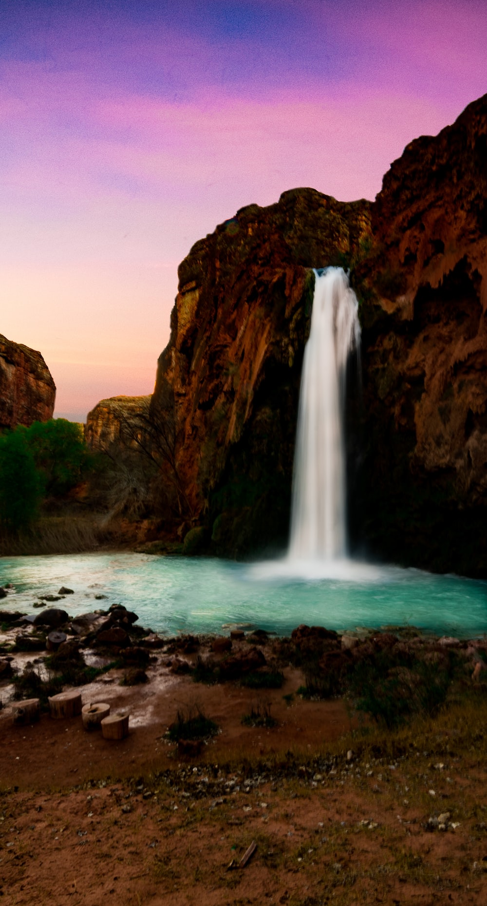 Waterfall pouring on body of water photo â free rock image on