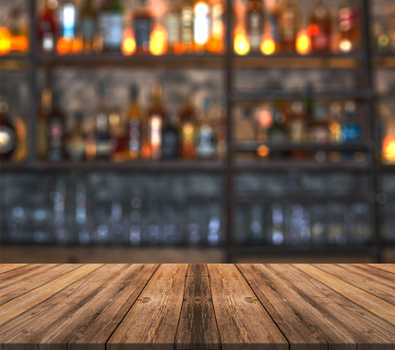 Bar with blurred lights bokeh and wooden table bar with blurred lights bokeh and wooden table stock photo