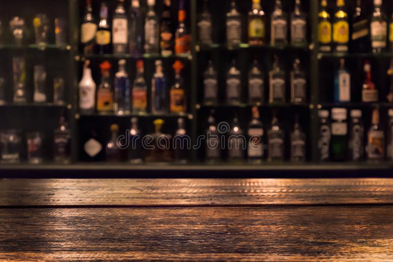 Empty wooden bar counter with defocused background stock photo