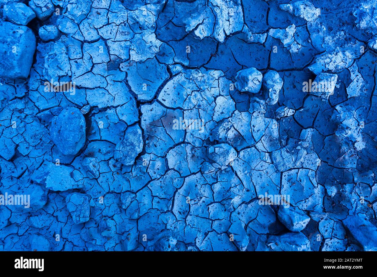Deep blue cracked ground background design stock photo