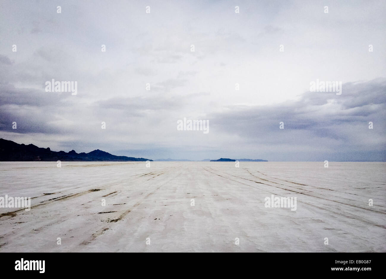 The bonneville salt flats with mountains in the distance cloudy stock photo