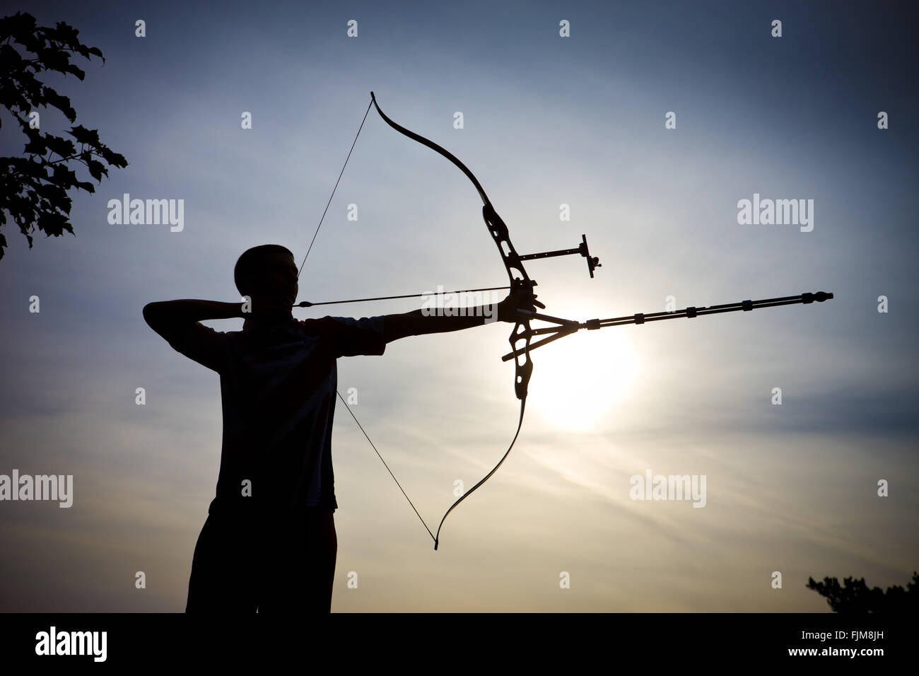 Iconic image of an archer firing an arrow with a bow stock photo