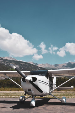 Single engine piston cessna parked at an airfield in the mountains