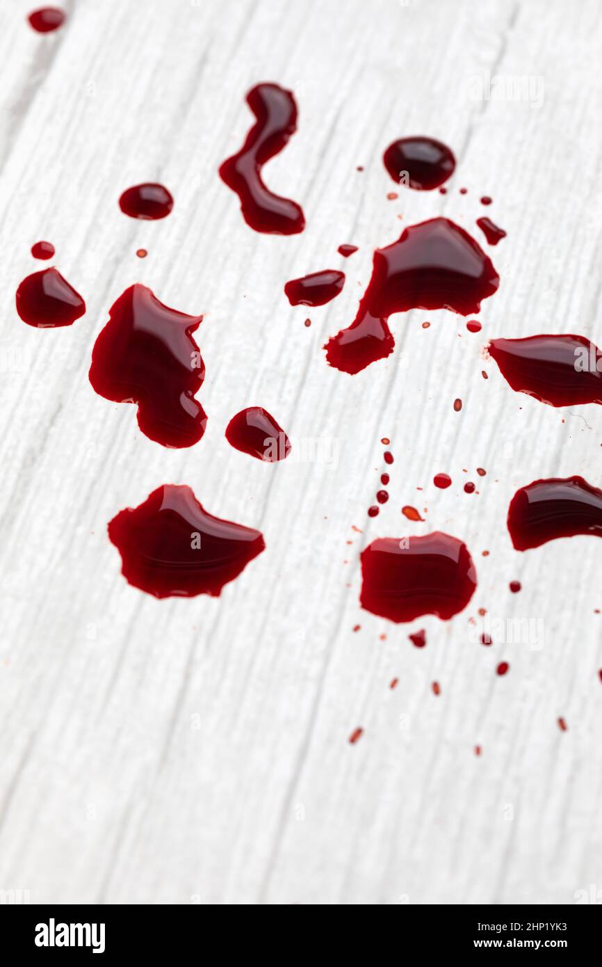 Blood stains on white wooden background dripped and splatterd blood with copy space injury wound concept space for text stock photo