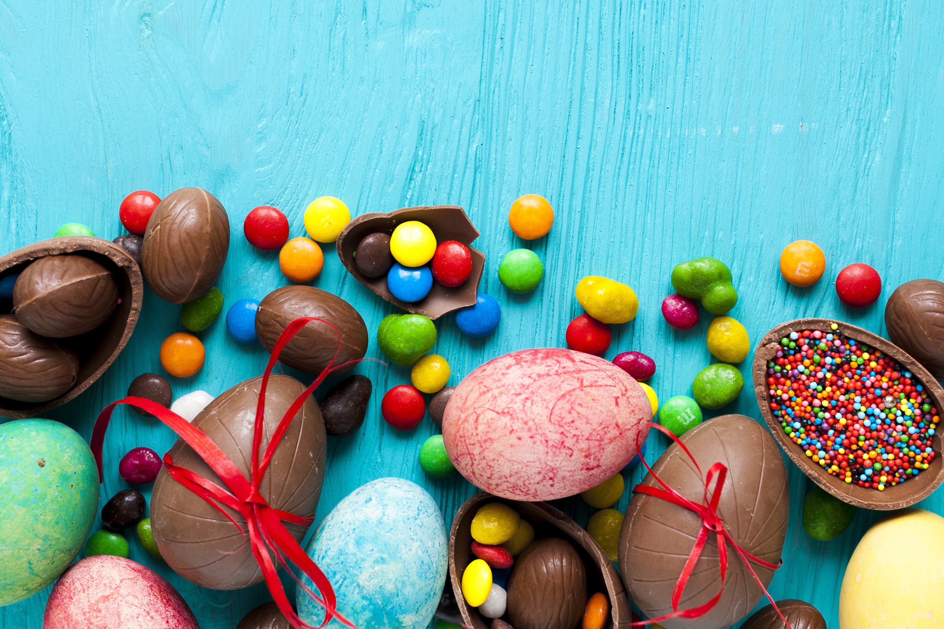Easter holidays candy chocolate colored background eggs