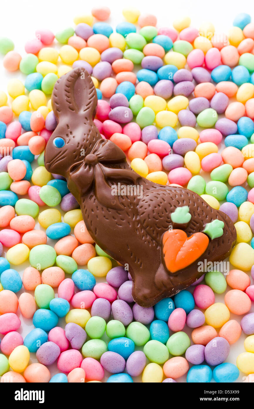 Chocolate easter bunny with other easter candies stock photo