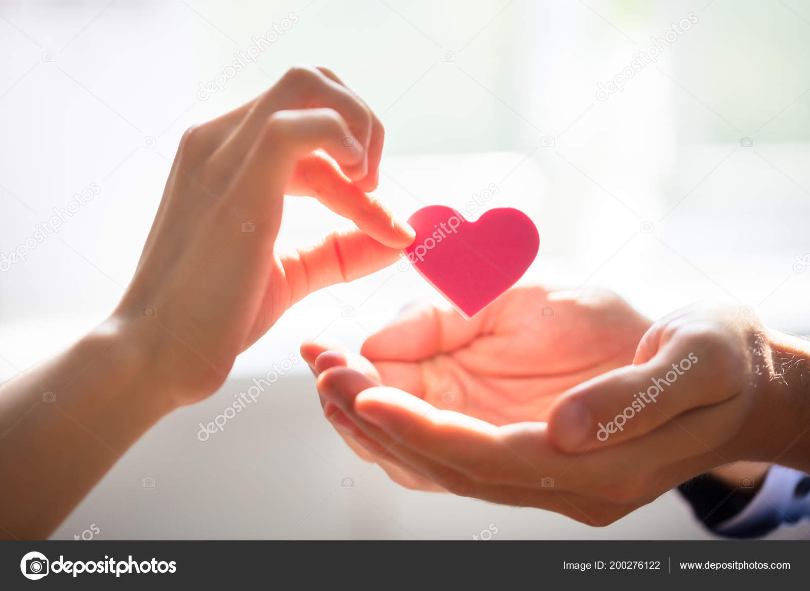 Close woman giving red heart mans hand stock photo by andreypopov