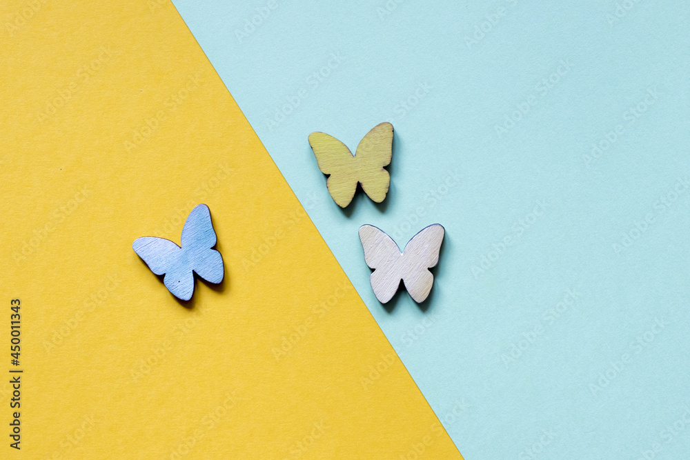 Beautiful colorful butterflies on a yellow and light blue background