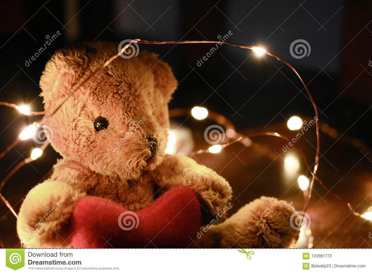 Teddy bear with warm led light stock photo