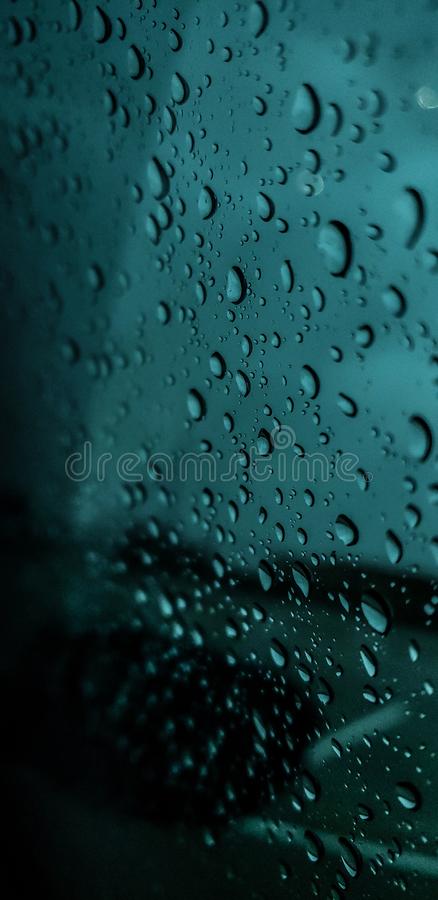Rainy day i love the rain it calms me down and is very peaceful to watch as the droplets collide with the glass window stock photo