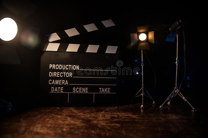 Movie concept miniature movie set on dark toned background with fog and empty space stock photo