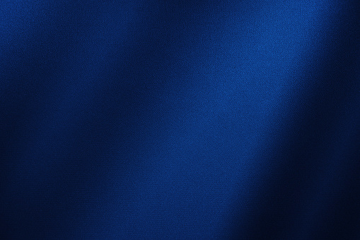 Abstract dark blue background silk satin navy blue color elegant background stock photo