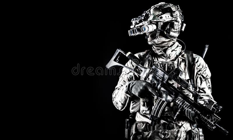 Soldier in night vision device on black background stock photo