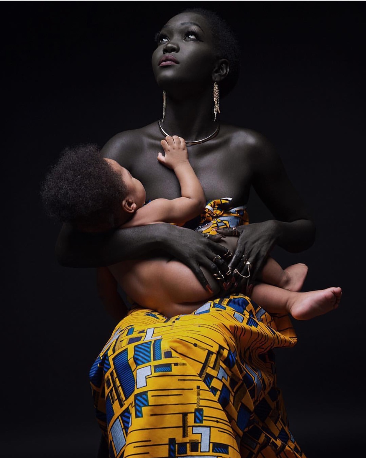 Pic of the day stunning photo of sudanese model nyakim gatwech holding a cute baby