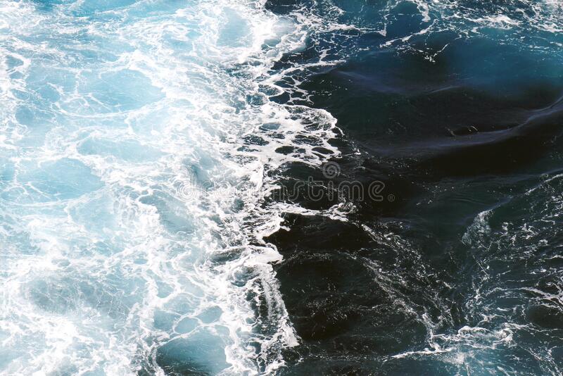 Ocean waves wallpaper dark blue water and sea foam from aerial view stock photo