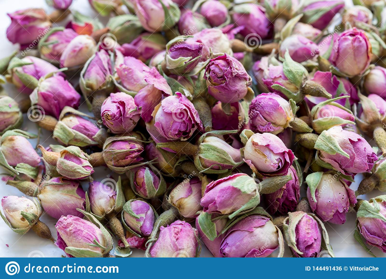 Heap of dried pink rosebuds for tea or aromatherapy rosebud textured flower background stock photo