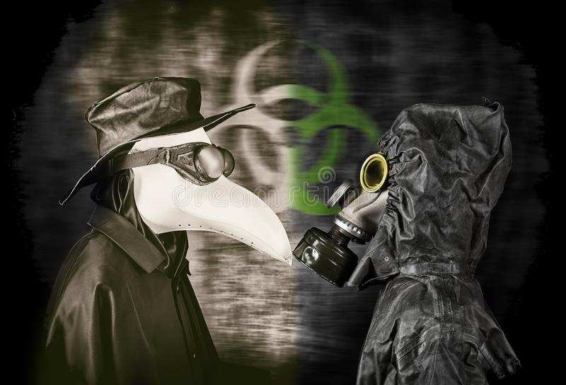 Plague doctor and man in gas mask stock photo