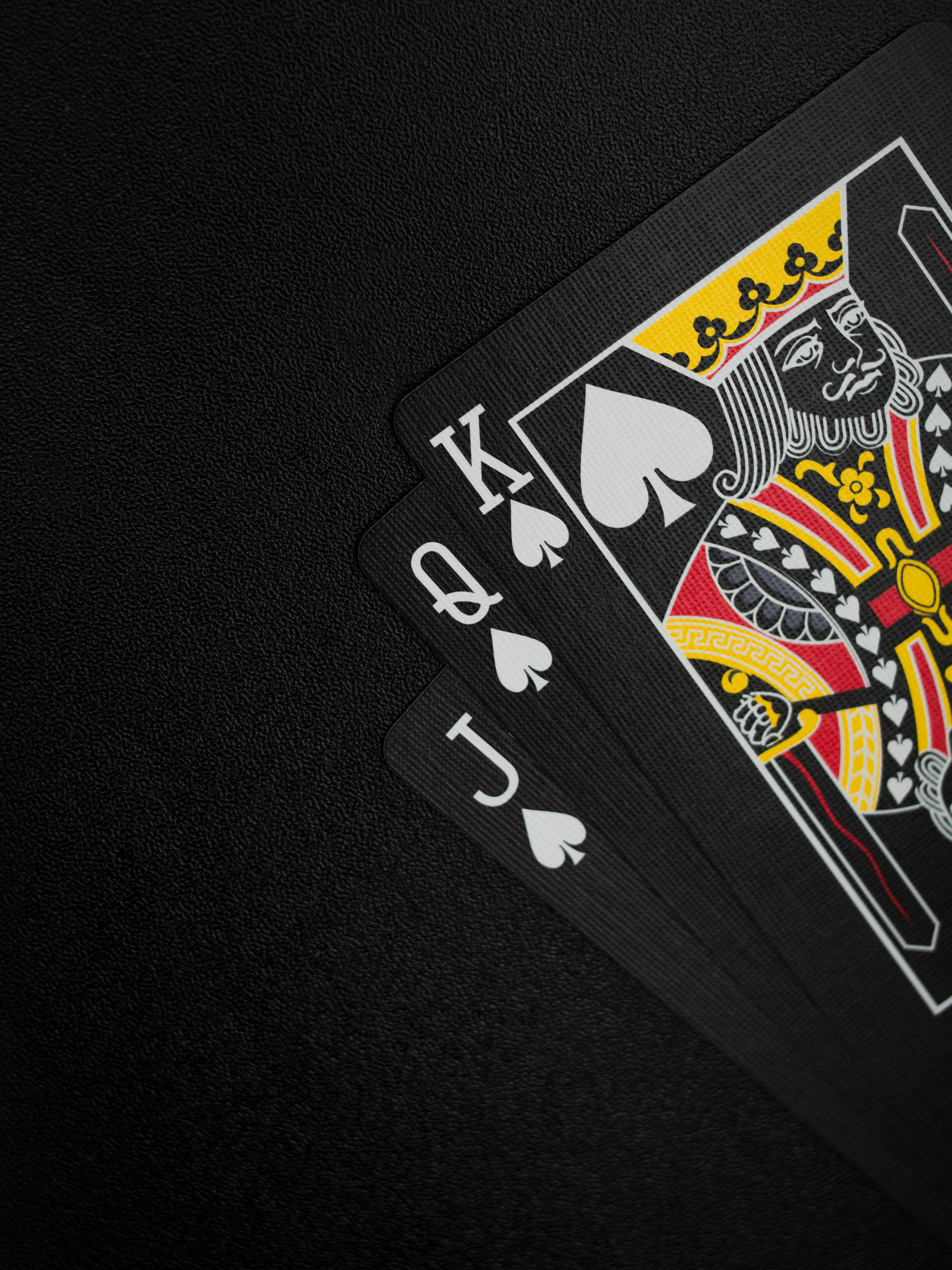 Black playing cards on black background