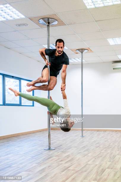 Male pole dance photos and premium high res pictures