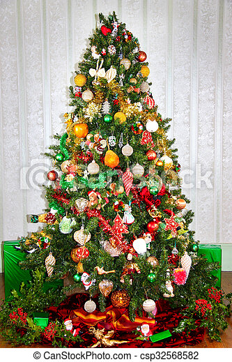 Colorful red green and gold christmas tree colorful red green and gold decorated christmas tree with fresh holly and gifts canstock