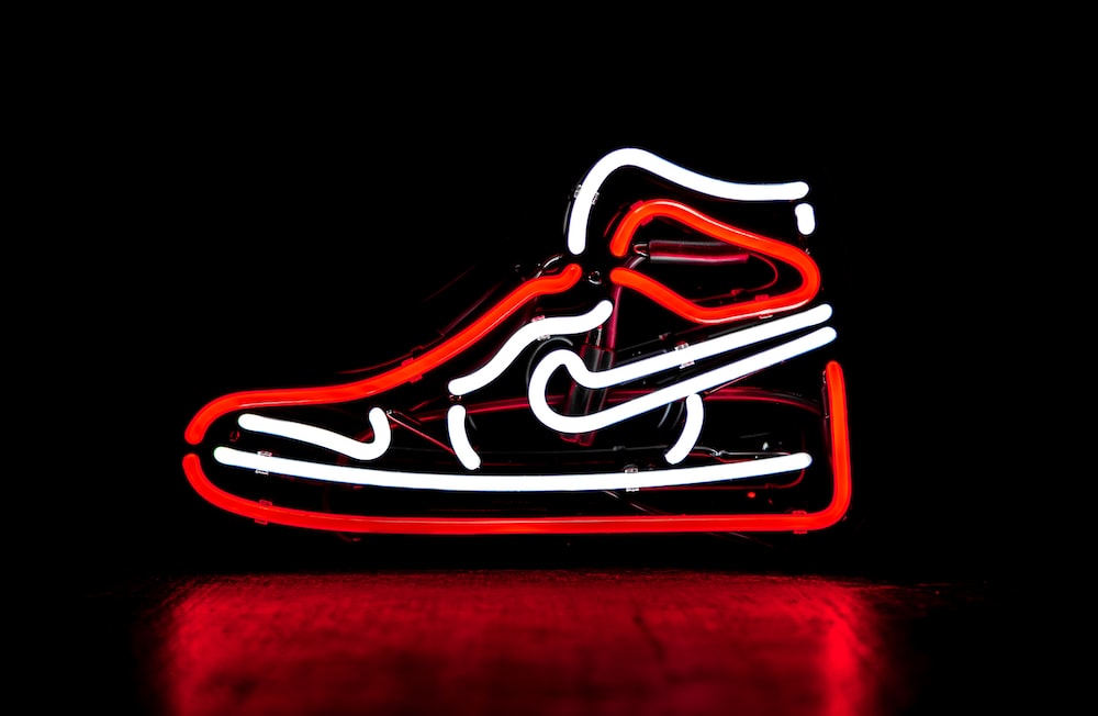 Red and white nike basketball shoe neon signage photo â free neon image on