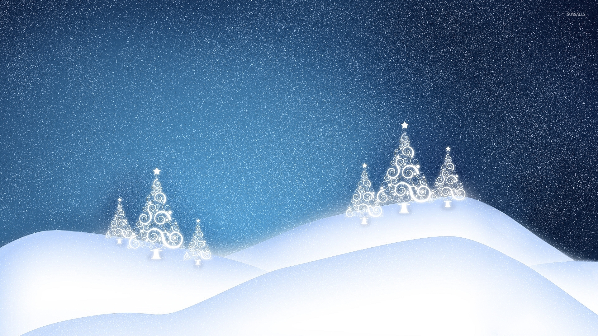 White glowing christmas tree on the snowy hills wallpaper