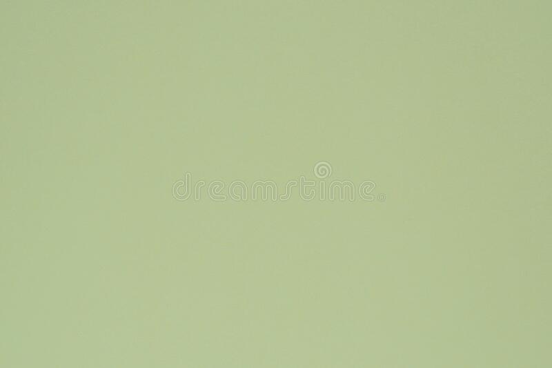 Light green colored paper surface irregularities spots and pores view from above background or wallpaper stock image