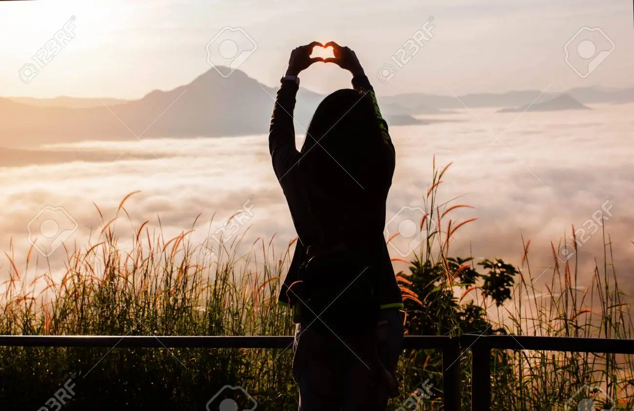 Young woman standing alone outdoor with wild forest mountains on background travel lifestyle and love concept rear viewwoman spreading hands with joy and inspiration in mountains stock photo picture and royalty free