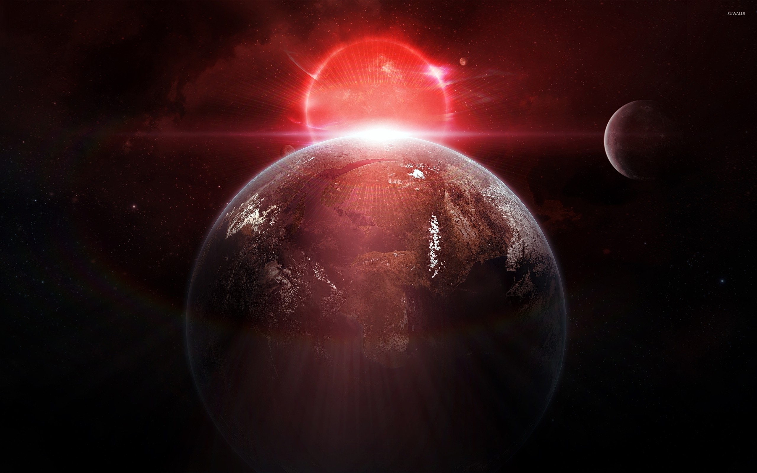 Red sun behind the planet wallpaper