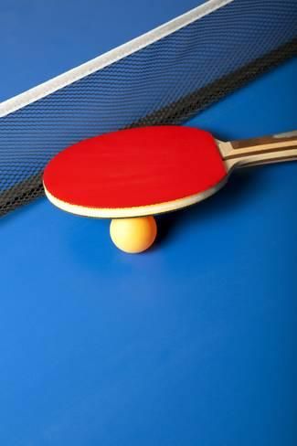 Table tennis or ping pong rackets and balls on a blue table photographic print