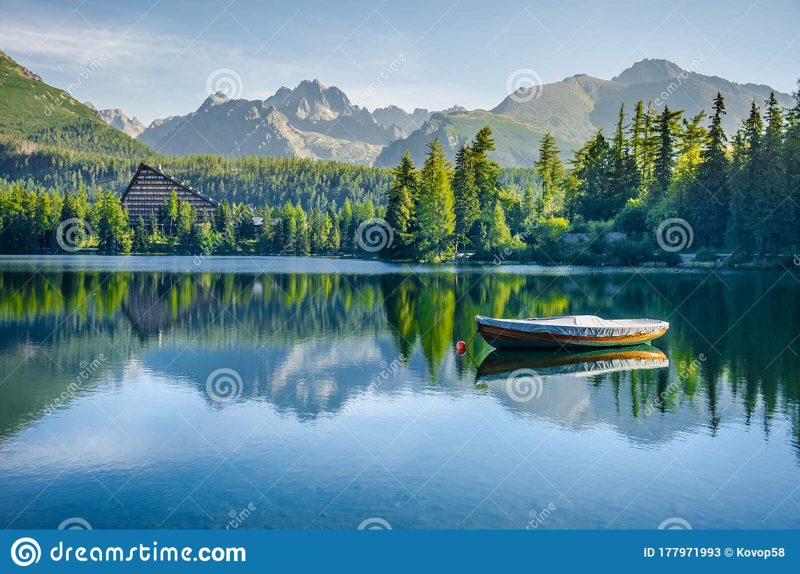 Alone boat on empty mountain lake strbske pleso in national park high tatra slovakia europe original wallpaper with soft colors stock image