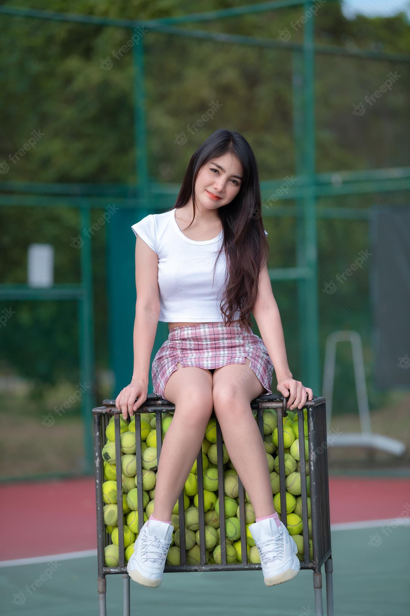Premium photo hipster asian girl pose for take a photofashion portrait pretty woman at tennis courtlifestyle of modern teenage thai girl