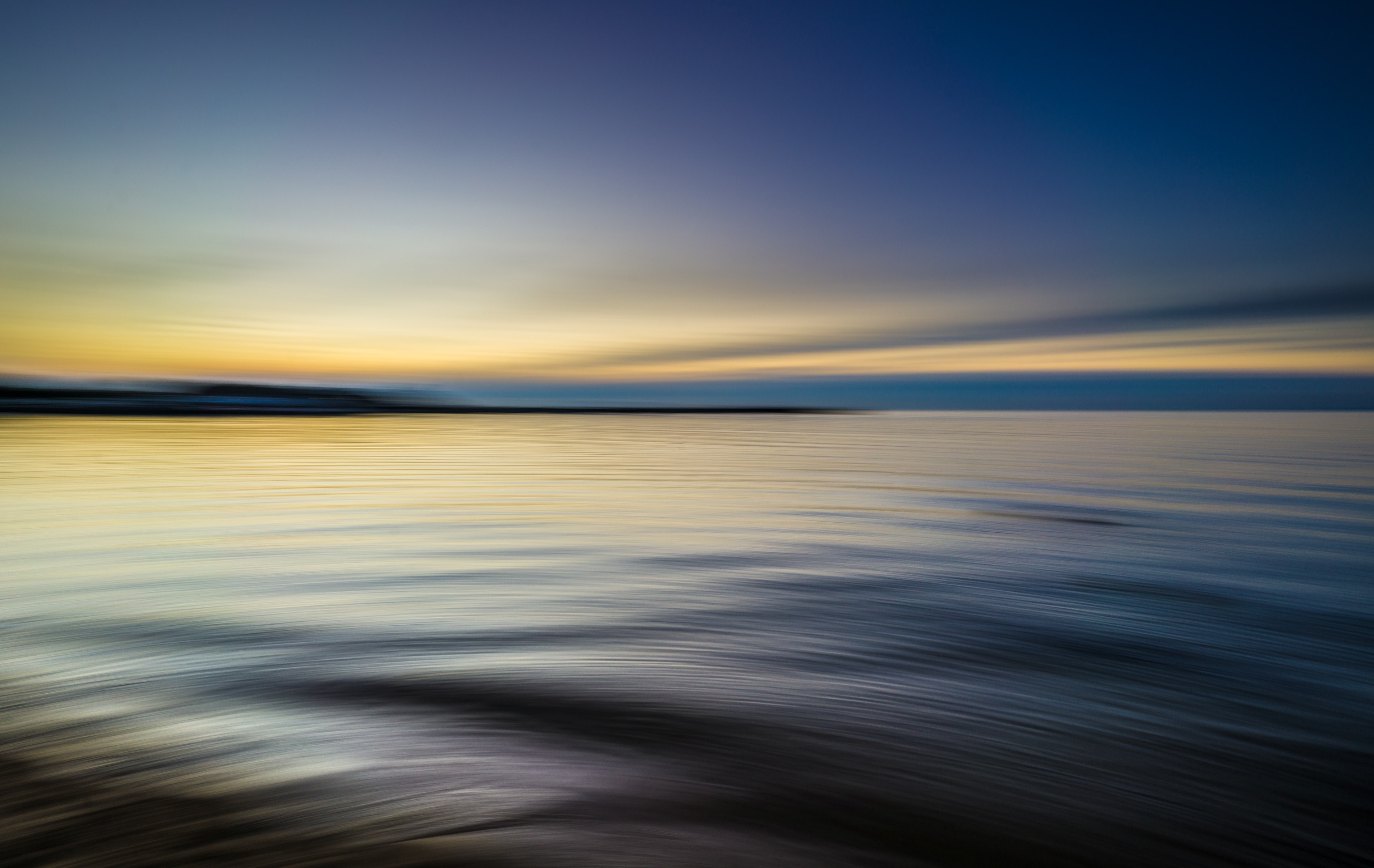 Wallpaper id tranquil rippling waters reflect a blue and yellow sky at sunset water sea calm and horizon hd k wallpaper free download