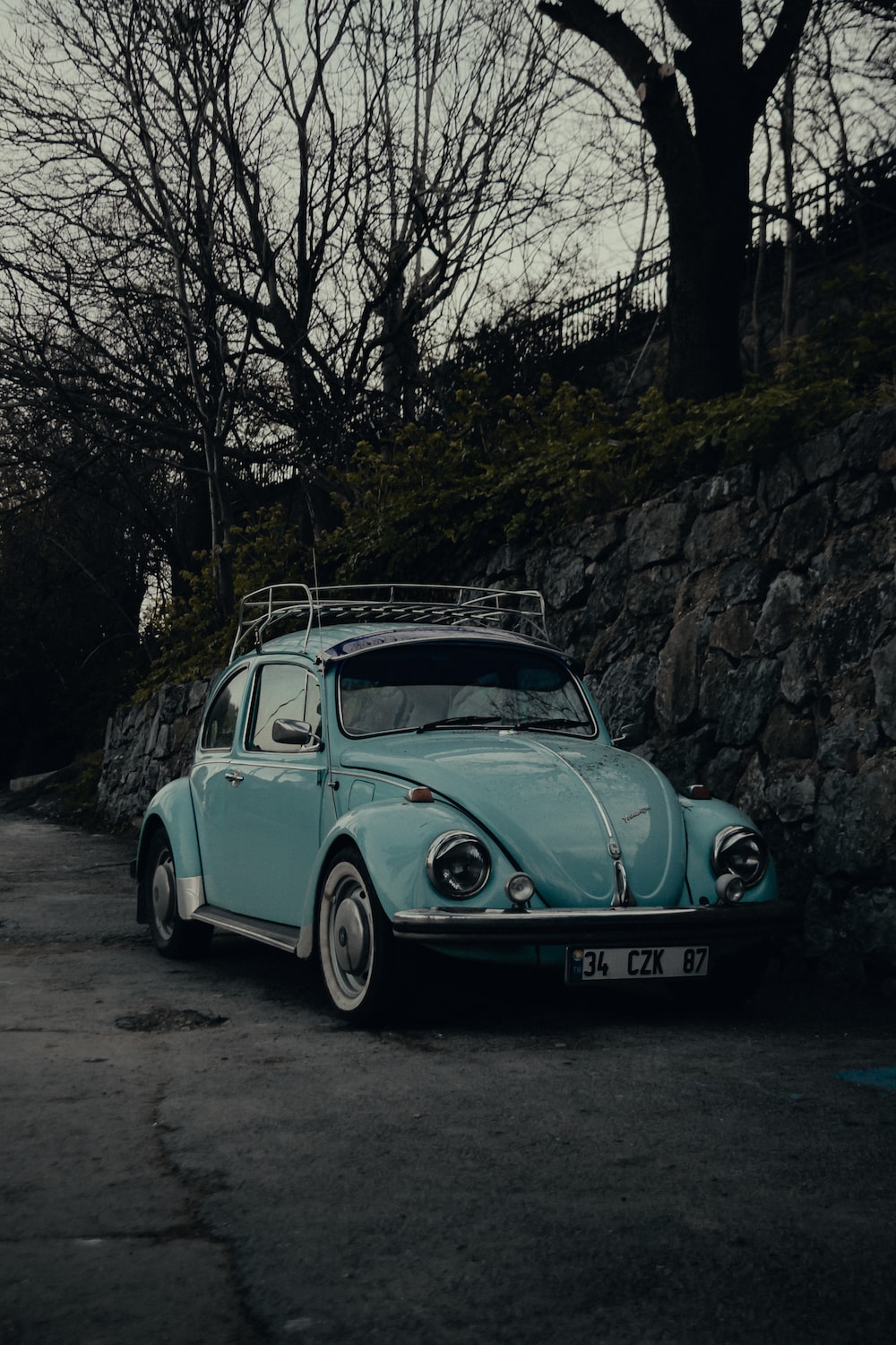 Teal volkswagen beetle parked beside tree photo â free vintage car image on
