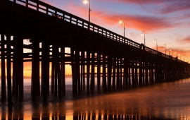 A Pier with Lampposts at Sunset