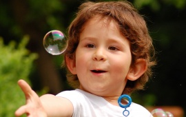 Happy Child Touching Bubble