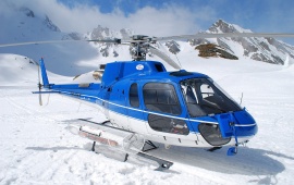 Helicopter In Snowy Mountains