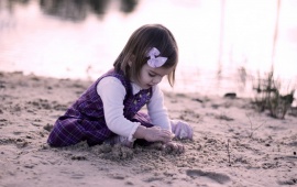 Little Girl Playing With Sand