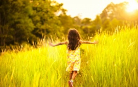 Little Girl Running On Meadow With Sunset