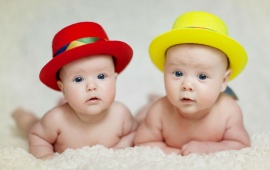 Red And Yellow Hat In Two Babies