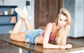 Sexy Blonde Laying On A Table