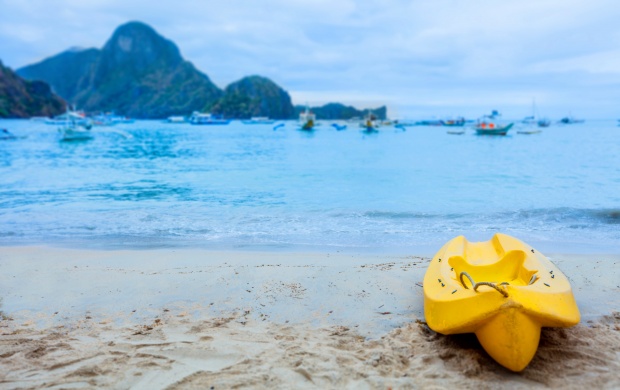 Small Yellow Boat On A Beach